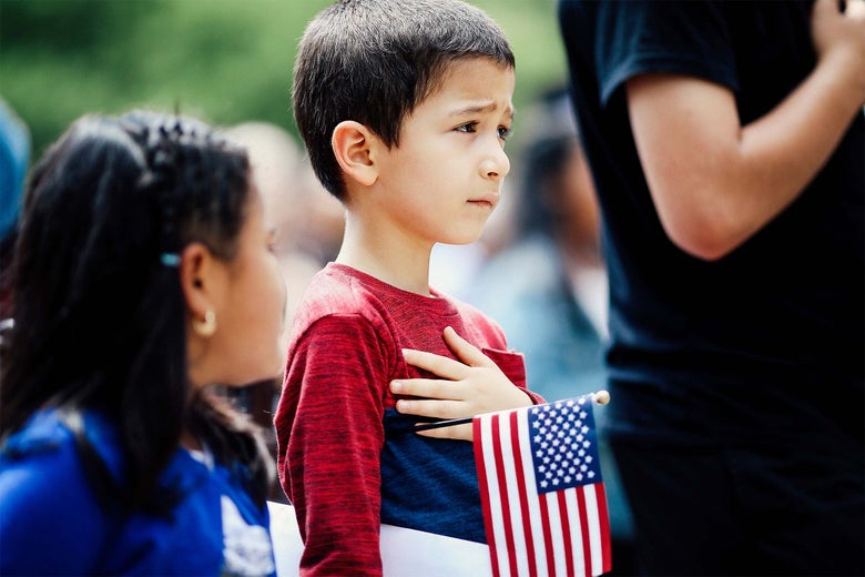 Children take the say the Pledge of Allegiance during a children's citizenship ceremony hosted by Citizenship and Immigration Services on May 31 in Washington.